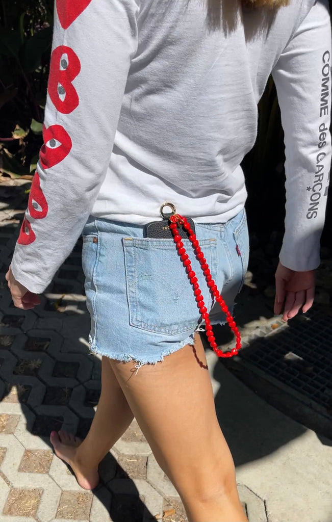 Love, love, love!! Hook on our signature red love heart wrist strap to your luxury leather phone case.  